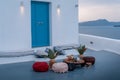 The location of the wedding ceremony on the island of Santorini with white chairs decorated with bouquets of flowers in Royalty Free Stock Photo