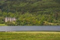 Loch Achray and ancient manor of Mor Trossachs, surrounded by thick woods Royalty Free Stock Photo