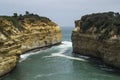 Limestone and sandstone cliffs with ocean waves and sunshine at Loch Ard Gorge, Great Ocean Road, Southern Victoria, Australia.