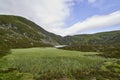 Loch Brandy in Glen Clova on a Summers afternoon, hidden by the Mountain escarpment that runs around it.