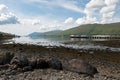 Loch Linnhe Pier in Fort William, Scotland at low tide with boulders in foreground