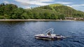 A man with a speed boat at Lake Lomond looking for tourists interrested for a ride, Lake Lomond, Scotland Royalty Free Stock Photo