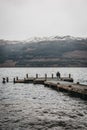 Man walking on a pier on Loch Lomond in Scotland