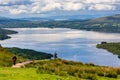 LOCH LOMOND, UNITED KINGDOM - MAY 31 2022: Hikers and walkers descending Conic Hill overlooking Balmaha and Loch Lomond in the