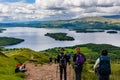 LOCH LOMOND, UNITED KINGDOM - MAY 31 2022: Hikers and walkers descending Conic Hill overlooking Balmaha and Loch Lomond in the