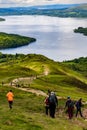 LOCH LOMOND, UNITED KINGDOM - MAY 31 2022: Hikers and walkers descending Conic Hill overlooking Balmaha and Loch Lomond in the