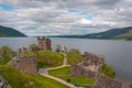 Panorama of the ruins of Urquhart Castle with tourists, Loch Ness, Scotland