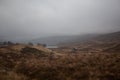 Loch Ossian peaking through the hills of Rannoch Moor, Scotland Royalty Free Stock Photo