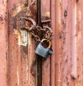 Lock on a chain on a rusty metal container Royalty Free Stock Photo