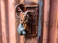 Lock on a chain on a rusty metal container Royalty Free Stock Photo