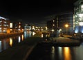 Clarence dock in leeds at night with buildings of the city reflected in the water Royalty Free Stock Photo