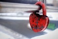 A lock in the form of a red heart engraved with the names of a couple in love, fixed on a silver metal fence Royalty Free Stock Photo