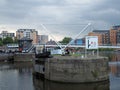 The lock gates on the leeds and liverpool canal at the entrance to clarence dock with knights bridge crossing the river and