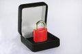 Lock in gift box. Red padlock with closed shackle in jewelry chest. Concept of security safe or protection software or hardware. Royalty Free Stock Photo