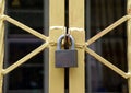 The lock on the gold metal fence, shape of the fence look like X