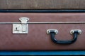 Lock and handle on old suitcase. Close up.