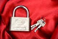 Lock with Keys isolated on red silk background