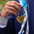 Lock with keys in the shape of a heart, golden metal, in a man`s hand, close up.Wedding heart`s. valentines card invitation. Royalty Free Stock Photo