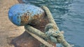 Lock mooring mechanism. Enlarged image of a large blue metal hook with a giant marine cable for towing ships. Focus on