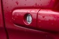 red car door handle with water drops Royalty Free Stock Photo