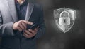 lock shield. cybersecurity concept. man holding a phone in his hand Royalty Free Stock Photo