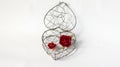 Lock Your Heart Concept, Single Abstract Curve Steel Container in Heart Like Shape with Paper Red Roses on White Background
