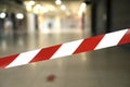 Lockdown background. Warning red white tape against the shopping mall Royalty Free Stock Photo