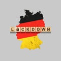 Lockdown. Germany. The inscription on wooden blocks, against the background of the map of Germany. Closing the country for