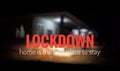 `Lockdown. home is the best place to stay` wordings on a blurred image of a house.