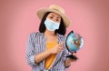 Sad Asian Woman Holding Globe, Wearing Face Mask Royalty Free Stock Photo