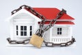 Lockdown: timber house with chain and padlock - home security concept Royalty Free Stock Photo