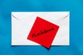 Lockdown word written on red color note pad on top of white envelope on blue background. Royalty Free Stock Photo