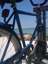 A Blue Bike Facing the Blue Sea