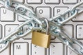 Locked chain on computer keyboard Royalty Free Stock Photo