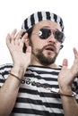 Locked, Desperate, portrait of a man prisoner in prison garb, over white background