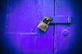 Locked door. Closed old rusty padlock on an old blue wooden door Royalty Free Stock Photo