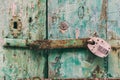 Locked door. Closed old rusty padlock on a distressed wooden door Royalty Free Stock Photo