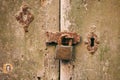 Locked door. Closed old rusty padlock on a distressed wooden door Royalty Free Stock Photo