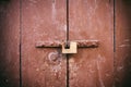 Locked door. Closed old rusty padlock on an old brown wooden door Royalty Free Stock Photo