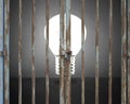 Locked door with lighting bulb and gray concrete wall