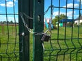 Locked door with lock playground behind the fence entrance prohibited pandemic