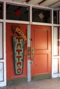 Old weathered doors with sign advertising tattoos on the second floor of building, downtown Austin, Texas, 2018