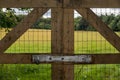 Locked fence by field Royalty Free Stock Photo