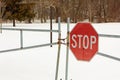 Locked gate with a stop sign