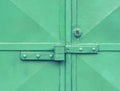 Locked green warehouse metal door. Detail view to locked latch Royalty Free Stock Photo