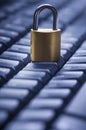 Locked metal padlock on blue computer keyboard. Data and password protection, internet and network security concept