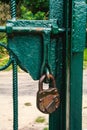 Locked old, antique padlock on the green gate. Royalty Free Stock Photo