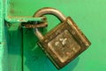 Locked old iron padlock on a green door. Royalty Free Stock Photo