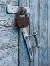 Locked old red double door with rusty padlock. Peeled door Royalty Free Stock Photo