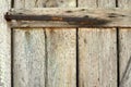 Locked old wooden door of a rural barn. Texture of a wooden board and rusty iron staples. Closed door of an ancient Royalty Free Stock Photo